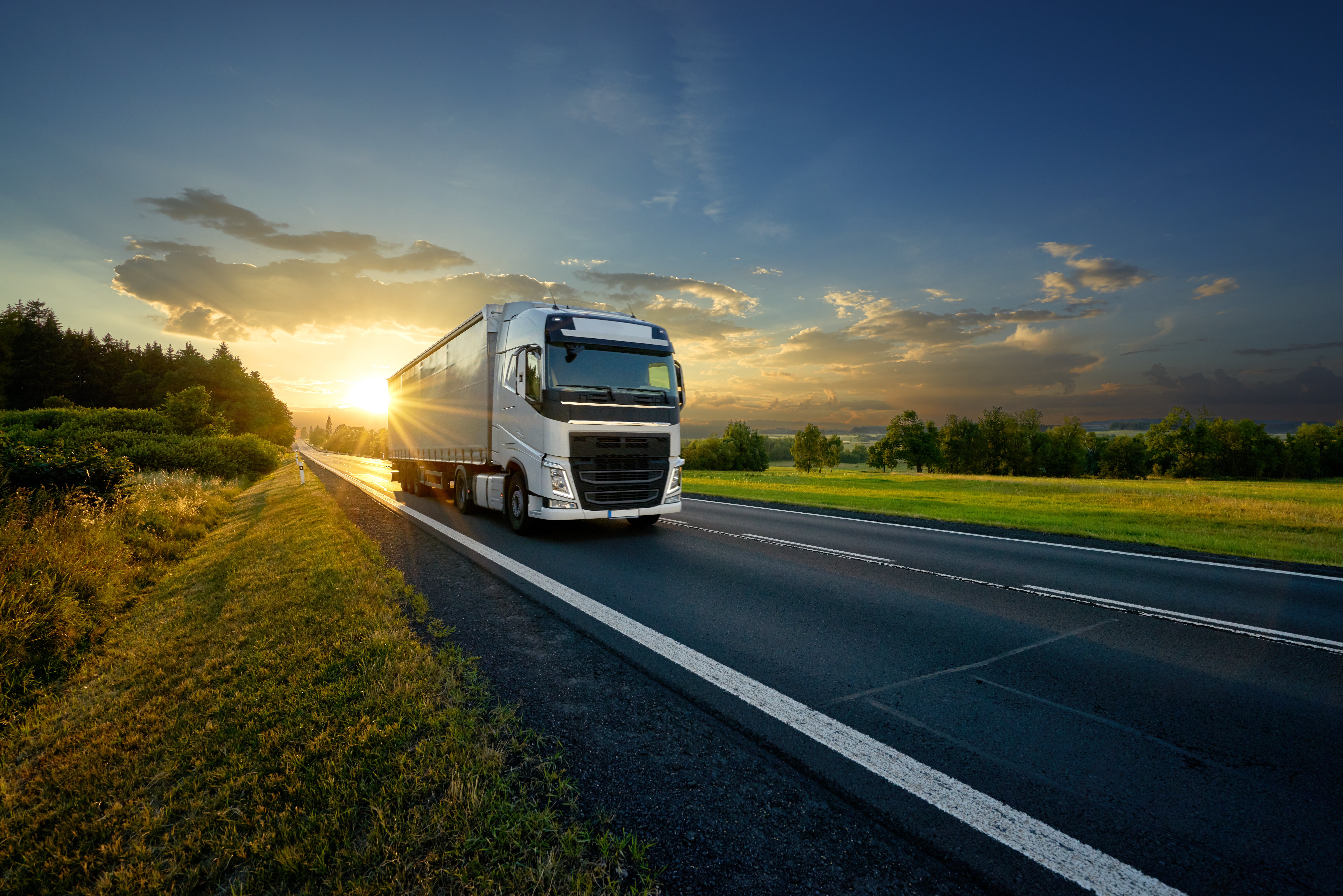 Large semi truck driving on the road while telematics in fleet tracking are sent to the home office