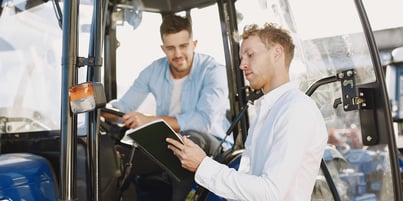 Fleet manager talking with a tractor driver using one of the company’s fleet assets