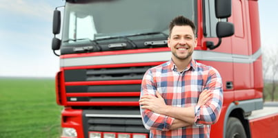 Fleet manager smiling in front of a fleet vehicle because he uses the best fleet management software