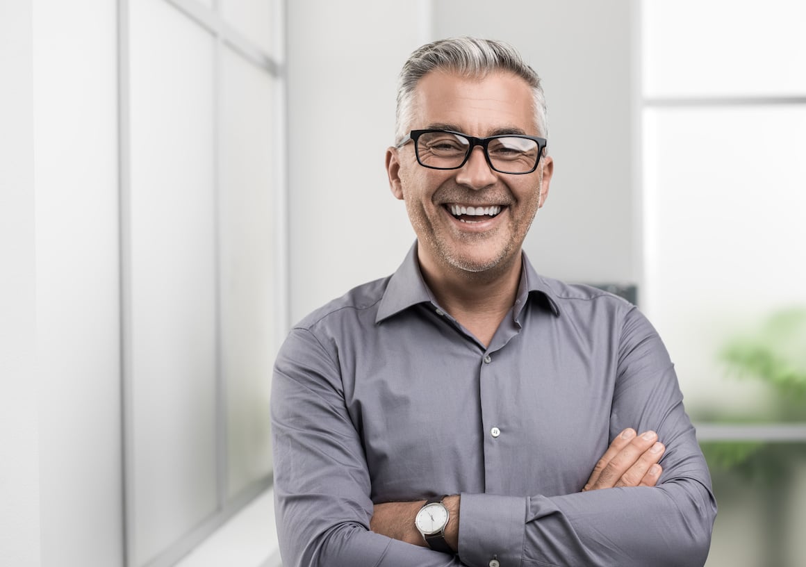 HVAC business owner smiling because he's finally able to grow his business.