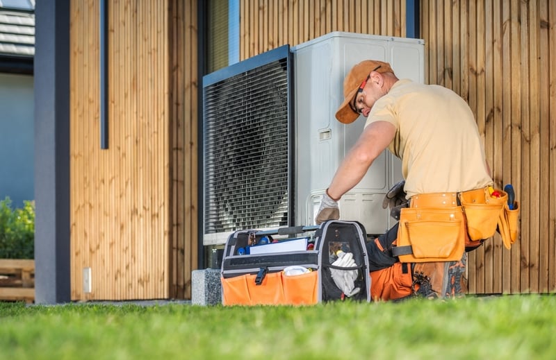 HVAC technician fixing air conditioning unit